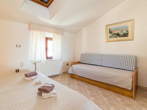 a bedroom with two beds and a window at Apartment Antonella & Napoletano-4 by Interhome in Umag