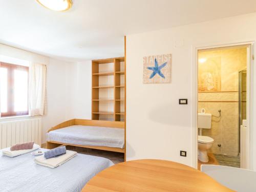 a small room with two beds and a bathroom at Apartment Antonella & Napoletano-1 by Interhome in Umag