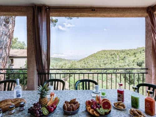 a table with fruits and vegetables on a balcony at Holiday Home A Mandria by Interhome in Ghisoni