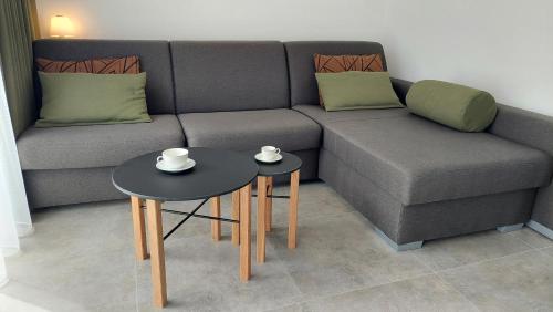 a living room with a couch and two tables at Apartmány Jura in Nová Pec