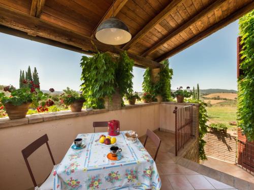 a table and chairs on a balcony with a view of a field at Apartment Cielo Stellato by Interhome in Campagnatico