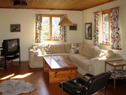 a living room with a couch and a coffee table at Holiday Home Järnemåla Margaretetorp - SND065 by Interhome in Valdemarsvik