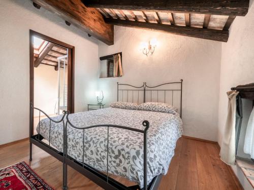a bedroom with a metal bed in a room at Holiday Home Domus Magna-2 by Interhome in Povoletto