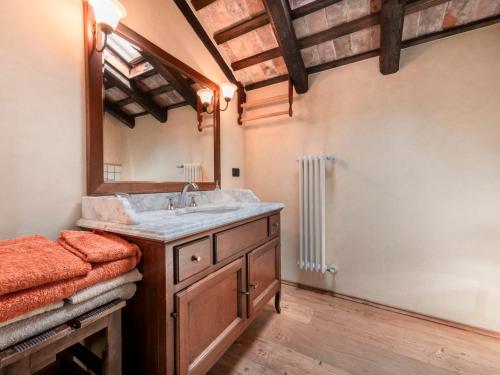 a bathroom with a sink and a mirror at Holiday Home Domus Magna-2 by Interhome in Povoletto