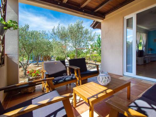 a living room with a table and chairs on a patio at Holiday Home Ivana by Interhome in Srima