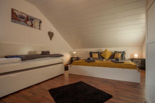 a bedroom with two beds in a attic at Apart Ritzkogel Willingen in Willingen