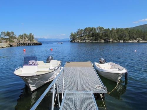 two boats are docked at a dock on a lake at Holiday Home Gamlahuset by Interhome in Bruntveit