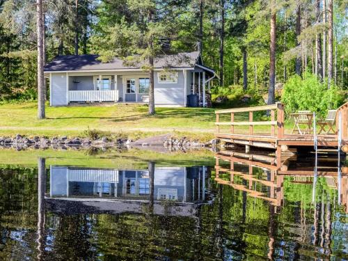 a house on the water with a dock at Holiday Home Piitterin saunatupa by Interhome in Juuka
