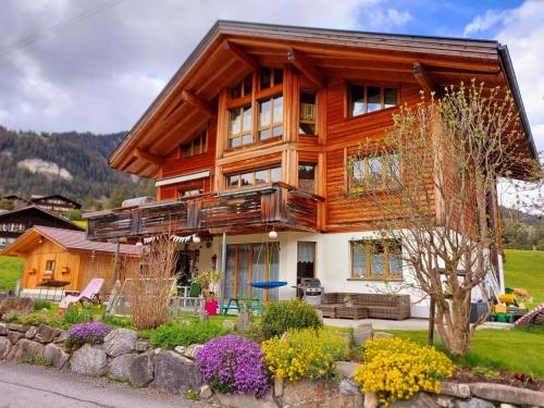 a large wooden house with a balcony at Apartment Lärchehuus by Interhome in Adelboden