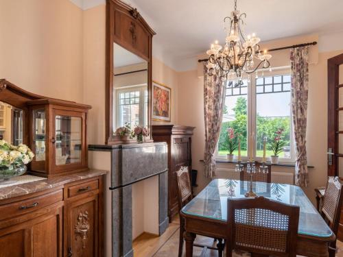a kitchen with a dining table and a chandelier at Villa Jasmine by Interhome in Mol