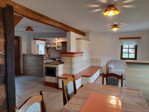 a kitchen and living room with a table and a dining room at Vineyard cottage Klobčar in Semič