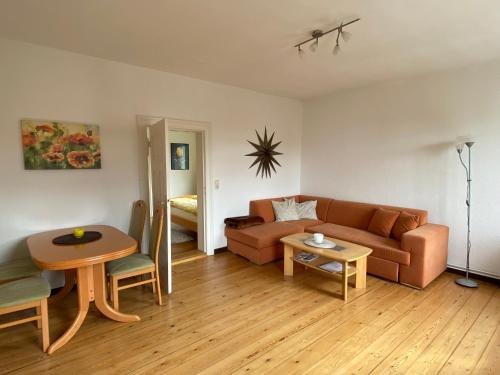 a living room with a couch and a table at Ferienwohnung Marta in Altefähr