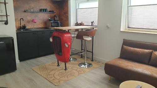 a kitchen with a red fire hydrant in a room at Appartement Bühl, zentral und ruhig, Soutterain in Bühl