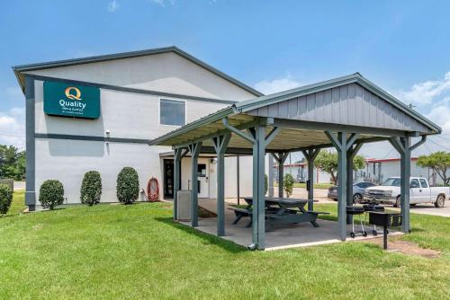 a building with a picnic table in front of it at Quality Inn & Suites Demopolis in Demopolis