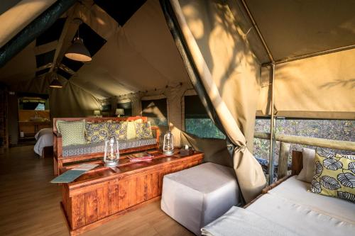 a tent with a table and chairs in it at Rukiya Safari Camp in Hoedspruit