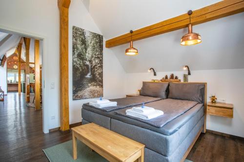 a bedroom with a bed and a table at Pine Cone Loft on Baden-Baden's Panorama Trail in Baden-Baden