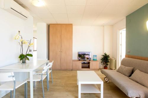 a living room with a couch and a table at Flats Friends Atlantida in Benidorm