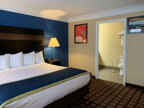 a hotel room with a large bed and a bathroom at Comfort Inn Saint Paul East in Oakdale