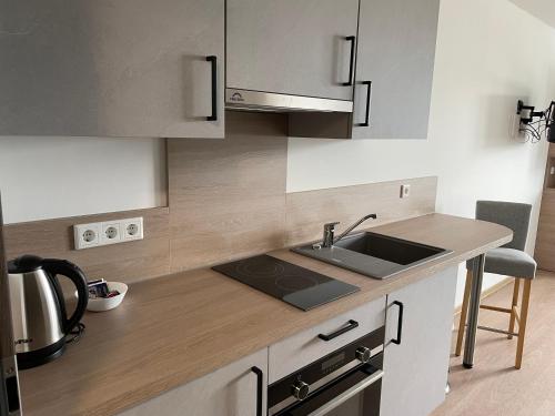 a kitchen with a sink and a counter top at Gästehaus Vondey in Salzkotten