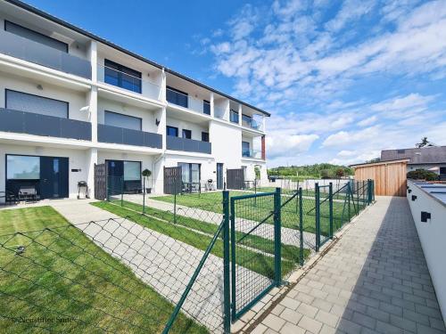 an apartment building with a fence in front of it at Friendship Suite in Mörbisch am See