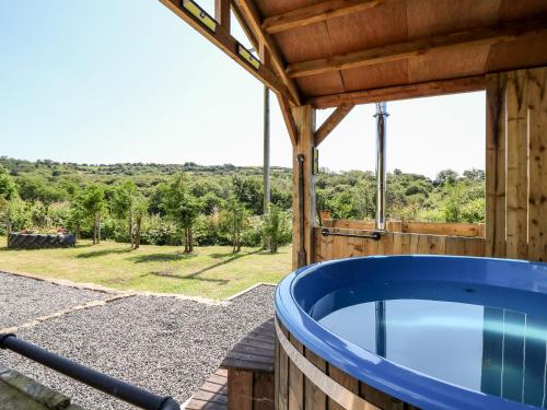 a hot tub on the deck of a house with a view at The Lodge in Llanelli