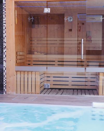 a row of wooden benches in a swimming pool at Helios Benidorm in Benidorm