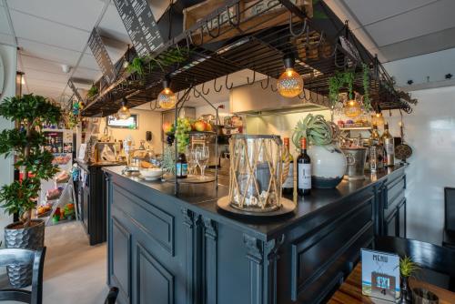 a counter in a store with plants on it at Chalet Ibiza in de duinen van IJmuiden aan Zee in IJmuiden