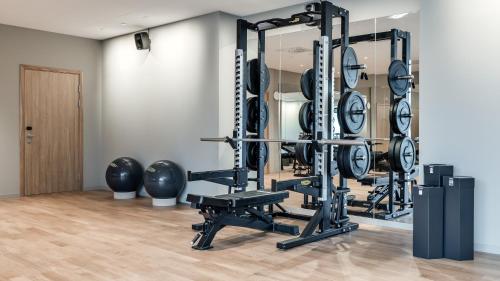 a gym with a row of weightlifting equipment at Clarion Hotel Sundsvall in Sundsvall