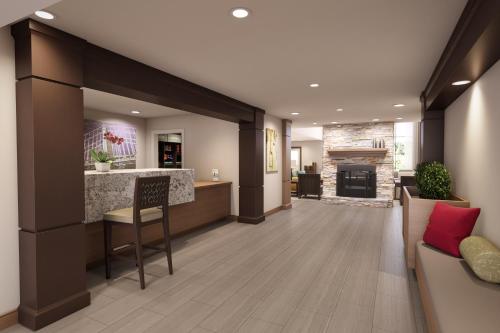 an office lobby with a bar and a fireplace at Staybridge Suites Quantico-Stafford, an IHG Hotel in Stafford