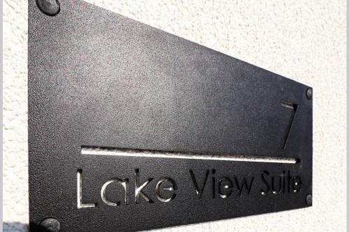 a black metal sign with the words lake view suite at Lake View Suite in Mörbisch am See