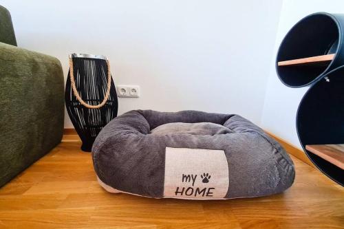 a dog bed sitting on the floor in a living room at Lake View Suite in Mörbisch am See