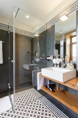 a bathroom with a sink and a shower at The Alpina Mountain Resort in Tschiertschen