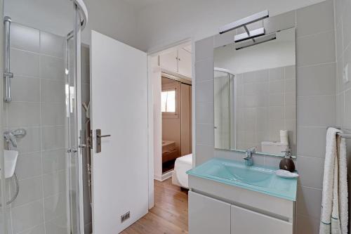 a bathroom with a blue sink and a shower at Vilamoura Golf Villa 1 by Homing in Vilamoura