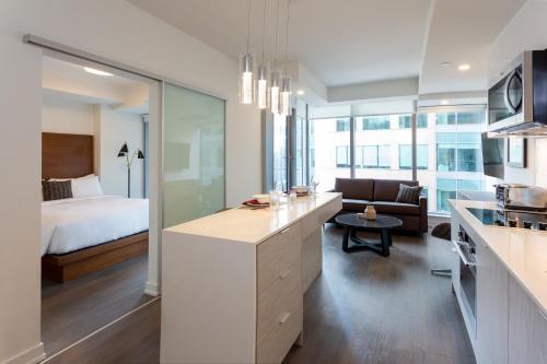 a kitchen and living room with a bed and a desk at reStays Ottawa in Ottawa