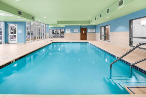 a swimming pool with blue water in a building at Holiday Inn Express & Suites - Suisun City, an IHG Hotel in Suisun City