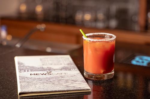 a drink sitting on top of a table with a napkin at Taj Wellington Mews, Mumbai in Mumbai