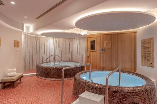 a room with two jacuzzi tubs in a building at Taj Wellington Mews, Mumbai in Mumbai