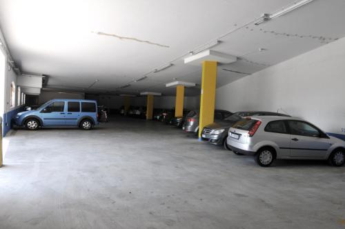 a parking garage with several cars parked in it at Alpenresort Belvedere in Molveno