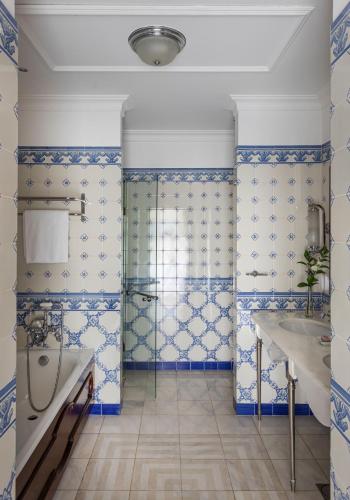 a bathroom with blue and white tiled walls at Reid's Palace, A Belmond Hotel, Madeira in Funchal