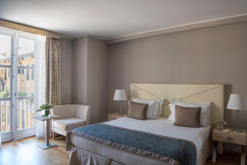 a hotel room with a large bed and a large window at Grand Hotel Portovenere in Portovenere
