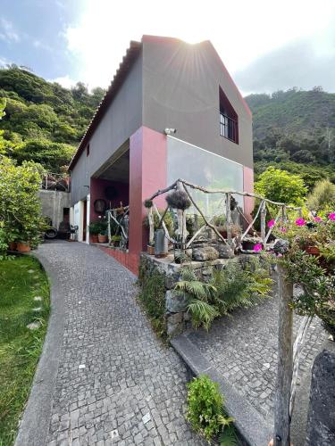 a building with a walkway in front of it at A Casa Estrelícia-Dourada Garcês in São Vicente