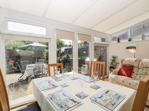 a dining room with a table and a couch at Clematis House in Dorchester