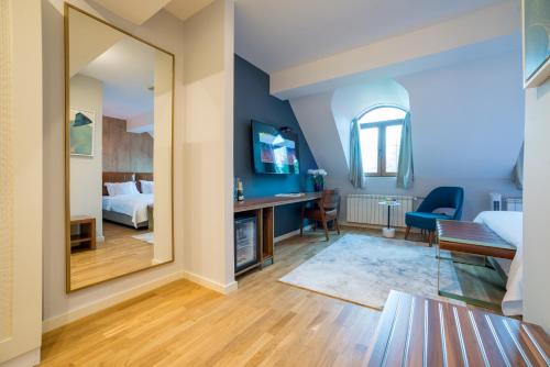 a bedroom with a bed and a mirror in a room at Ski Hotel in Žabljak