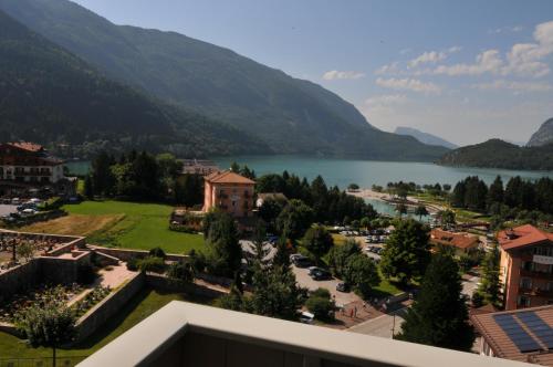 a view of a town with a lake and mountains at Alpenresort Belvedere in Molveno
