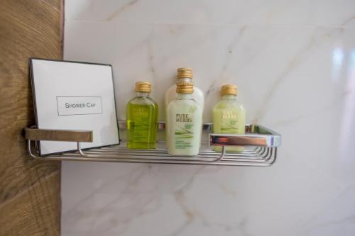three bottles on a shelf in a bathroom at Ski Hotel in Žabljak