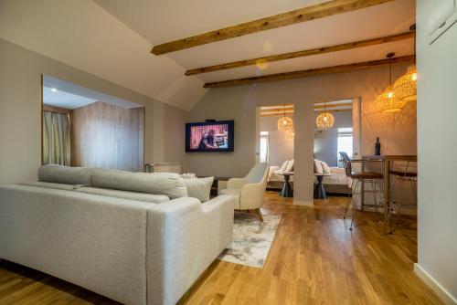 a living room with a couch and a dining room at Ski Hotel in Žabljak