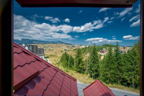 a view from a window of a road and trees at Ski Hotel in Žabljak