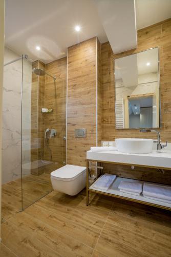 a bathroom with a sink and a toilet and a shower at Ski Hotel in Žabljak