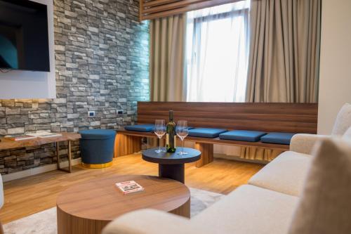 a living room with wine glasses on a table at Ski Hotel in Žabljak