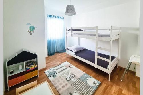 a room with two bunk beds and a table at Family Suite in Mörbisch am See